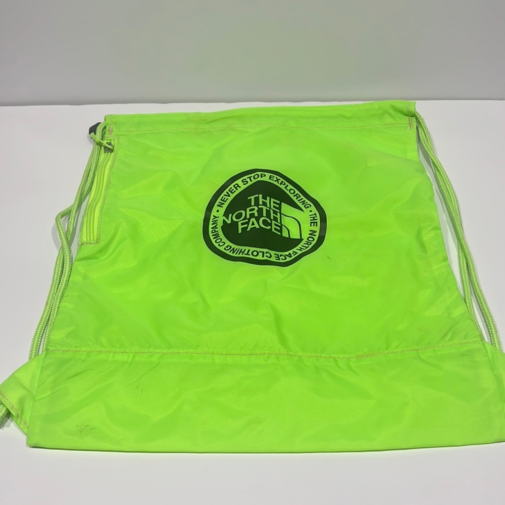 neon green drawstring backpack + north face